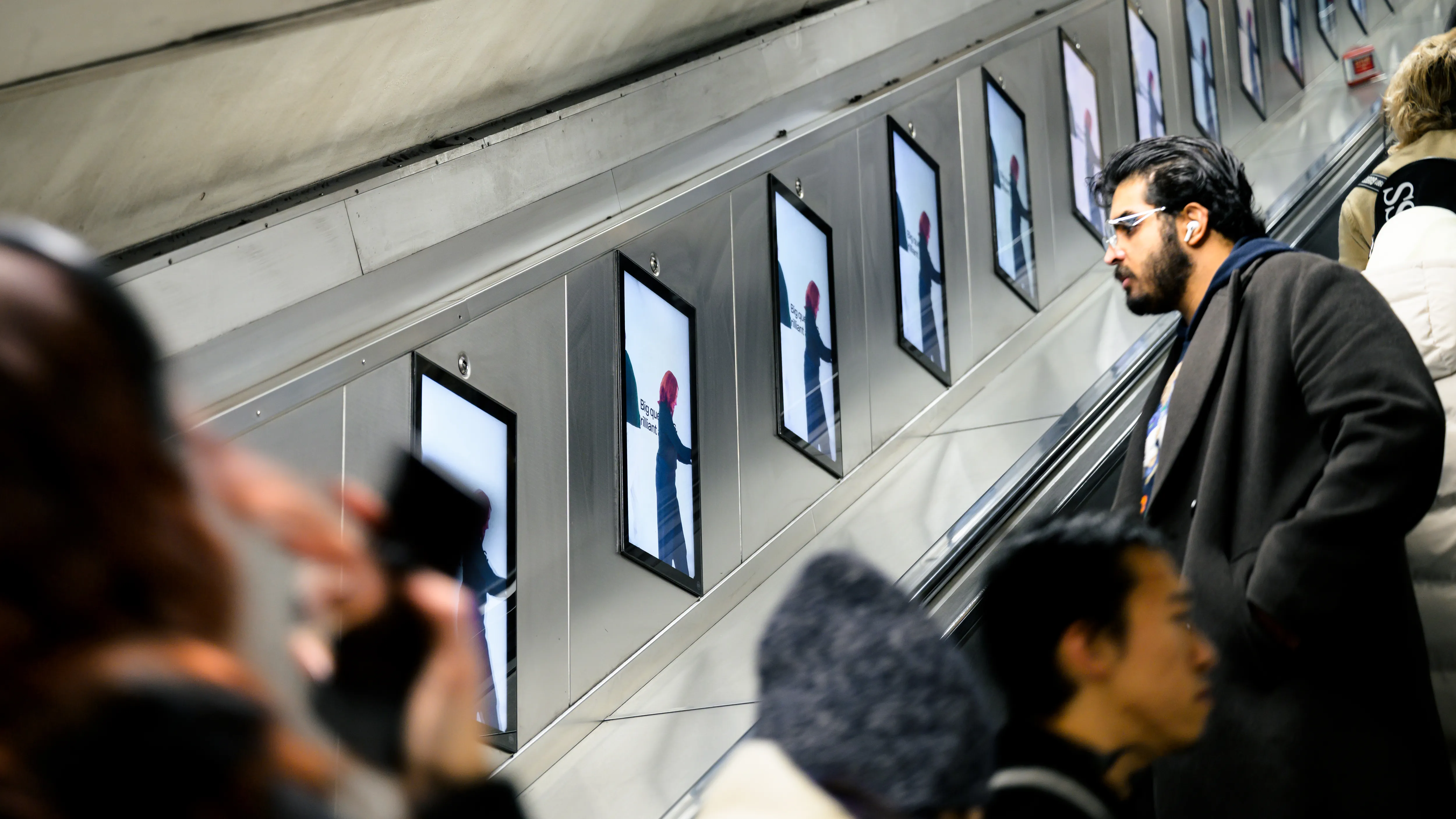 The Rest Is Science digital escalator panel on the London Underground