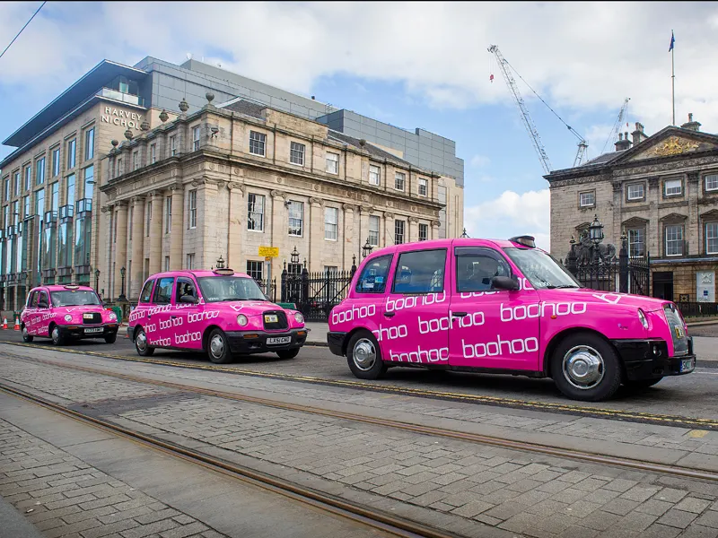 Fleet of taxis with full boohoo advertising wraps